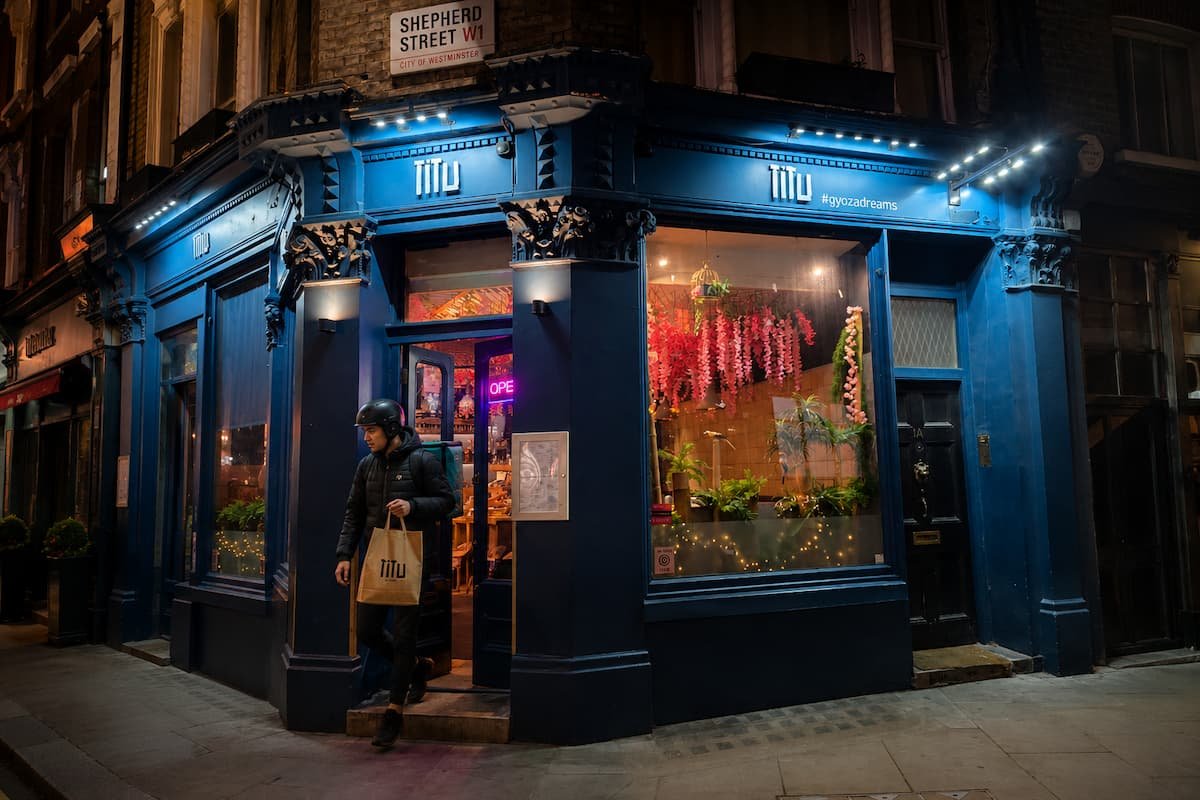 A delivery rider leaving Titu on Shepherd Street with a Japanese fusion order