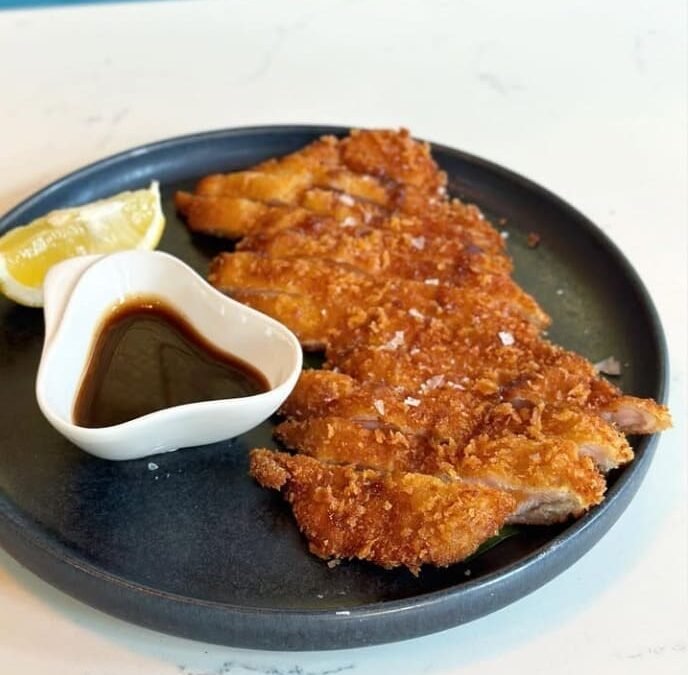 Chicken katsu served with its dipping sauce at Titu