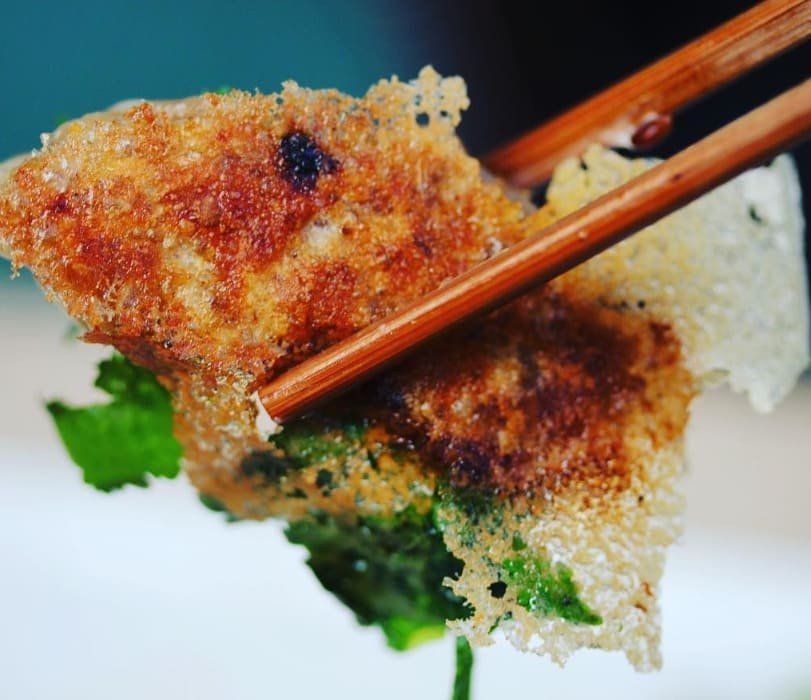 Gyoza with its crisp lace skirt lifted with chopsticks at Titu