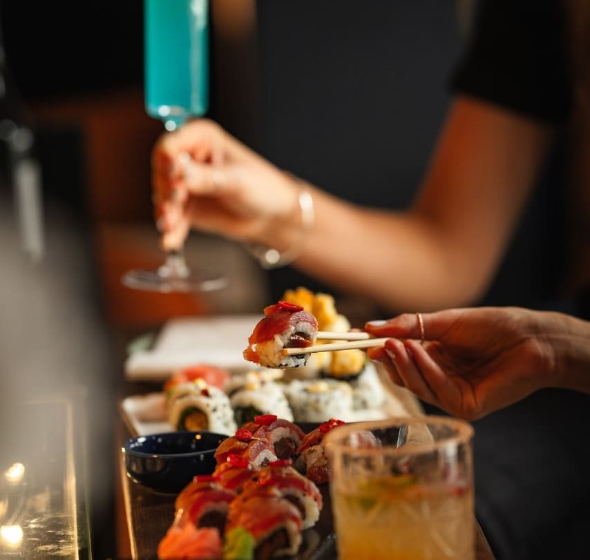 Diners sharing sushi and cocktails at Titu Japanese fusion restaurant London