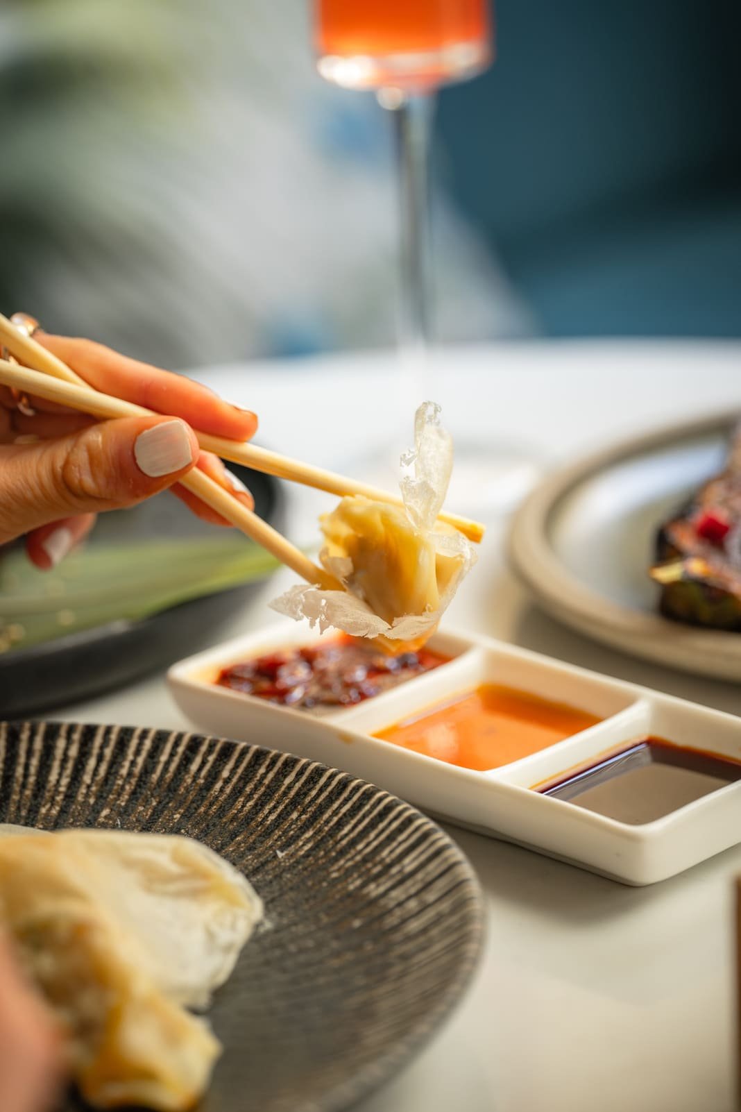 Handmade gyoza served with three dipping sauces at Titu, Mayfair