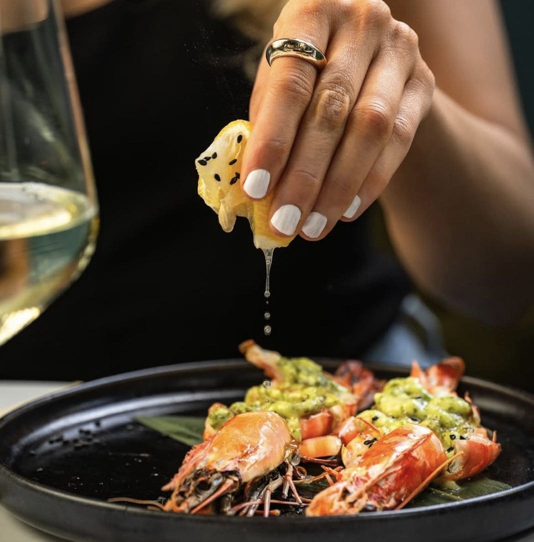 Lemon squeezed over grilled prawns at Titu Mayfair London