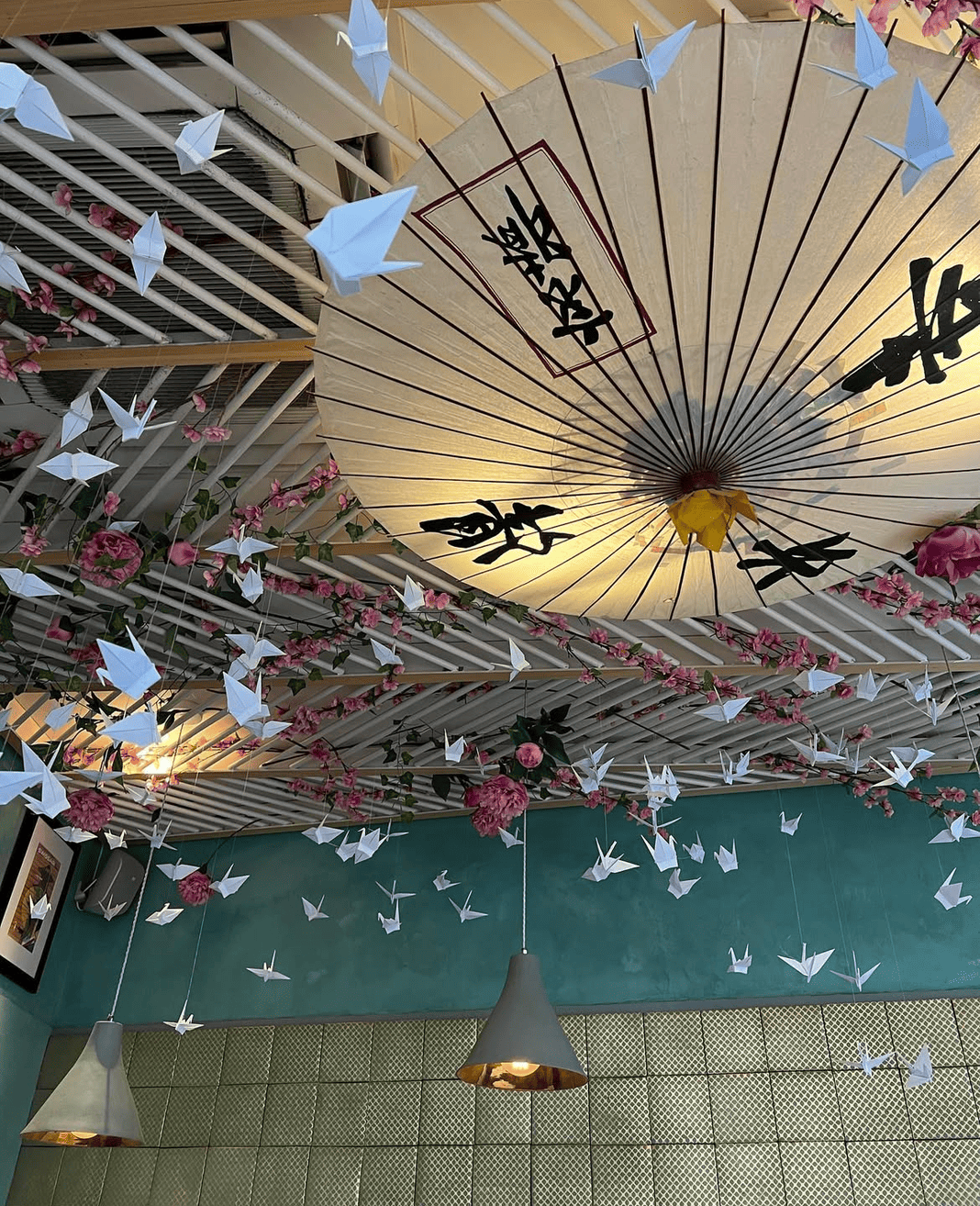 Paper parasol and origami crane ceiling inside the dining room at Titu, Mayfair