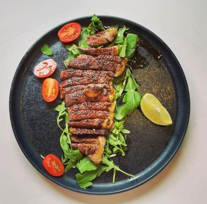 Sliced wagyu tataki with rocket and ponzu at Titu, London