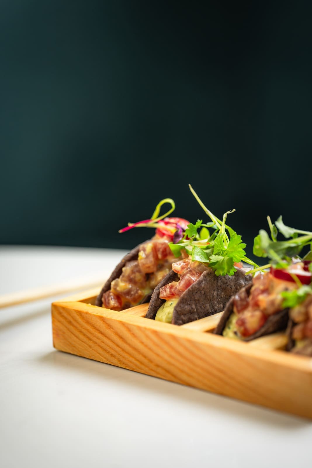 Wagyu tacos lined on a wooden board at Titu, Mayfair